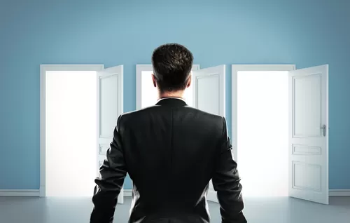 man standing in front of three open doors