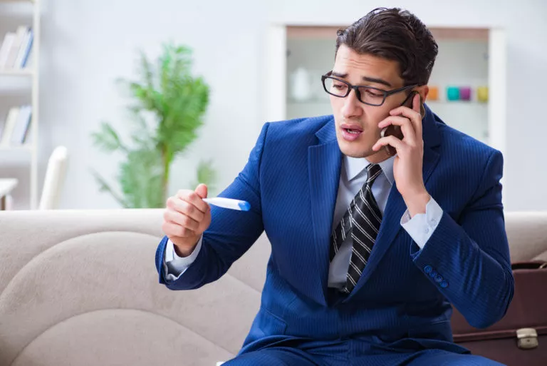 man wearing a navy suit on the phone